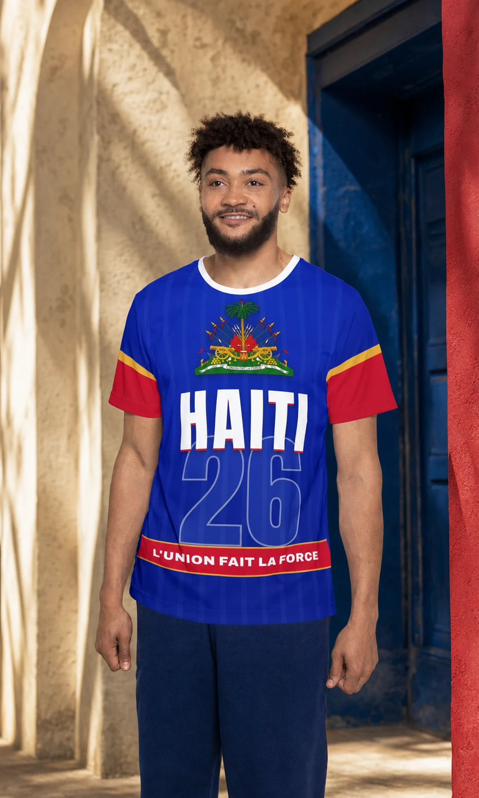 Model wearing the blue, red, and gold Les Grenadiers Haiti fan jersey